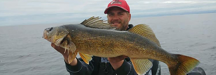 Fishing Guide Green Bay WI Captain Jay Stephan Holding A Walleye